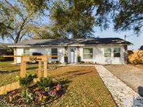 Charming single-story home featuring a welcoming front yard with a decorative stone walkway at 2002 Sutton Rd, Lakeland, FL 33810