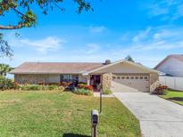 Charming single-story home with stone accents, lush landscaping, and a well-manicured lawn at 288 Hernando Rd, Winter Haven, FL 33884