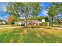 Ranch-style home with landscaped yard and circular driveway at 2943 Plantation Rd, Winter Haven, FL 33884