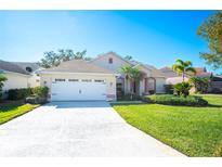 One-story house with attached garage and manicured lawn at 4340 Winding Oaks Cir, Mulberry, FL 33860