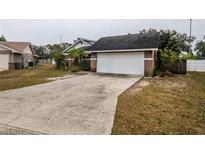 Brick home with attached garage and a long driveway at 6102 N Fork Ct, Lakeland, FL 33809