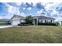 Single-story house with attached garage and well-manicured lawn at 1548 Normandy Heights Blvd, Winter Haven, FL 33880