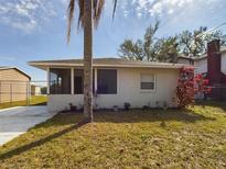 Cute one-story house with a screened porch and a palm tree in the front yard at 162 N 2Nd St, Eagle Lake, FL 33839