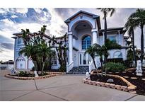 Grand two-story home with a circular driveway and lush landscaping at 3001 Crystal Beach Rd, Winter Haven, FL 33880