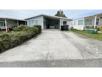 Mobile home with carport and paved driveway at 50989 Highway 27 # 8, Davenport, FL 33897