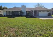 Ranch-style home with a large yard and attached garage at 2314 York Pl, Lakeland, FL 33810
