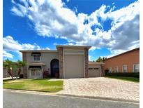 Charming two-story home with a brick driveway and well-manicured lawn at 4193 Limerick Dr, Lake Wales, FL 33859