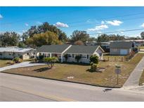Charming single-story home with a well-manicured lawn and a detached garage at 615 E Haines Blvd, Lake Alfred, FL 33850