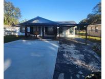 Cute one-story home features a covered porch and carport at 916 25Th Nw St, Winter Haven, FL 33881