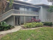 Inviting condo building exterior with lush landscaping at 117 Palm View Ct # 3537, Haines City, FL 33844