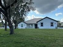 Traditional single-story home featuring a spacious lawn and well-maintained landscaping at 2510 Lakefront Dr, Lake Wales, FL 33898