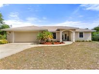 Charming single-story home featuring a two-car garage, complemented by fresh landscaping and a cozy front yard at 2772 Indian Pipes Trl, Frostproof, FL 33843