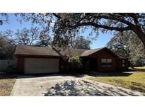 Charming single-story home with a two-car garage, set back from the street with mature trees and landscaping at 3710 Black Jack Ct, Lake Wales, FL 33898