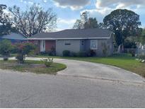 Charming single-story home with a well-maintained lawn and circular driveway at 108 Prospect Ave, Winter Haven, FL 33880