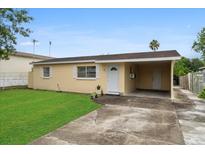 Ranch-style home with carport and well-maintained lawn at 1330 Skyview Blvd, Lakeland, FL 33801