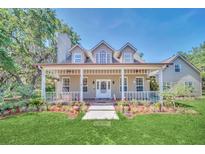 Two-story house with a wraparound porch and landscaped yard at 21113 Kissimmee Shores Rd, Lake Wales, FL 33898