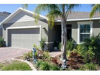 Charming single-story home with a well-manicured front yard, beautiful garden bed, and attached garage at 3112 St Charles Pl, Winter Haven, FL 33884