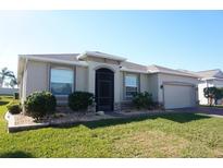 One-story home with two-car garage, landscaping, and brick driveway at 3926 Bedford Ave, Winter Haven, FL 33884