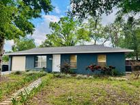 Inviting single-story home featuring a well-manicured lawn and charming landscaping at 4089 Lana Dr, Lakeland, FL 33813