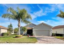 Single-story home with attractive landscaping and a two-car garage at 5341 Nicklaus Dr, Winter Haven, FL 33884