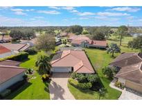 Aerial view of a single Gathering home with a tile roof and lush landscaping at 768 Canberra Rd, Winter Haven, FL 33884
