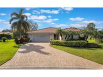 Charming single Gathering home featuring a paver driveway and mature landscaping at 768 Canberra Rd, Winter Haven, FL 33884