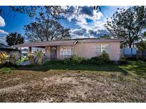 Charming single-story home with a classic front porch and mature landscaping at 115 Jefferson St, Lake Wales, FL 33859