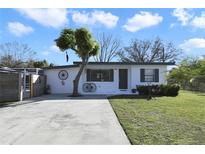 Charming single-story home with a well-manicured lawn and mature trees at 1817 Mckeown Ave, Haines City, FL 33844