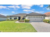 Beautiful single-story home featuring a well-manicured lawn and a two-car garage at 230 Crescent Ridge Rd, Auburndale, FL 33823