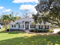 Well-manicured lawn and landscaping accent this attractive single story home at 4 Lake Eloise Ln, Winter Haven, FL 33884