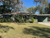 Charming single-story home with lush front yard landscaping and attached carport at 618 Chester Dr, Lakeland, FL 33803