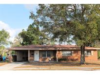 Charming single-story brick home with a covered carport and mature landscaping in the front yard at 807 S 1St St, Lake Wales, FL 33853
