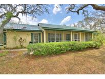 Charming single-story home with a screened-in porch and mature trees at 151 W Hamlin Trl, Frostproof, FL 33843