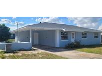 Charming single-story home featuring a covered carport, and a well-maintained front yard at 1536 Sarah St, Lake Wales, FL 33898