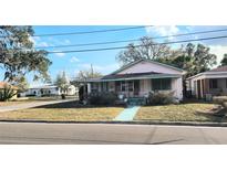 Charming single Gathering home featuring a cozy front porch and well-maintained lawn at 201 Dr J A Wiltshire W Ave, Lake Wales, FL 33853