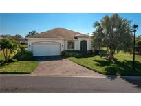 Charming single-story home with a manicured lawn and brick-paved driveway leading to a two-car garage at 3834 Bedford Ave, Winter Haven, FL 33884