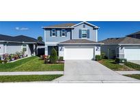 Charming two-story home featuring a well-maintained lawn and a two-car garage at 578 Preserve Pointe Blvd, Davenport, FL 33837