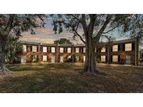 Charming brick townhomes featuring black shutters, white doors, and a spacious common area at 5850 Cypress Gardens Blvd # 206, Winter Haven, FL 33884