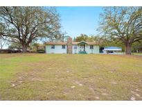 Charming single story home with large front yard and mature shade trees at 660 Duggers Way, Lake Wales, FL 33859