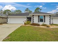 Charming single-story home with a well-manicured lawn and attached two car garage at 734 Canberra Rd, Winter Haven, FL 33884