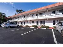 The exterior of this multi-Gathering home features balconies, assigned parking and meticulously maintained landscaping at 1100 Martinique Dr # 106, Winter Haven, FL 33884