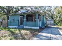 Charming home featuring a screened front porch, classic architectural details, and a detached garage at 1325 4Th Ne St, Winter Haven, FL 33881