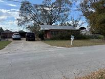 Cozy single-story home with a concrete driveway and mature tree in front yard at 201 Cleveland Avenue, Winter Haven, FL 33881