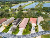 A vibrant aerial view showcasing homes nestled amidst lush landscaping and serene lakes at 20143 Sunset Landing Ave, Groveland, FL 34736