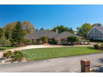 Charming single-story home boasts a circular driveway, mature landscaping, and neutral color palette at 2506 Partridge Dr, Winter Haven, FL 33884