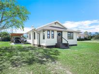 Charming single-story home with a well-maintained lawn and covered carport, perfect for a Gathering at 2606 Tall Palm Ave, Lake Wales, FL 33898