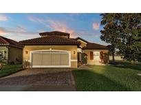 Charming home features a well-manicured lawn, two-car garage and a tile roof at 369 Villa Sorrento Cir, Haines City, FL 33844