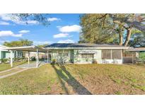 Charming single-story home featuring a screened porch and carport at 634 Formosa Pl, Bartow, FL 33830