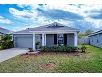 Charming single-story home with well-maintained lawn and a one-car garage, freshly landscaped at 708 Simone Ct, Haines City, FL 33844