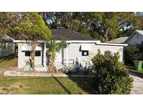 Charming single-story home with a well-maintained lawn, and a welcoming front porch at 1328 3Rd Ne St, Winter Haven, FL 33881